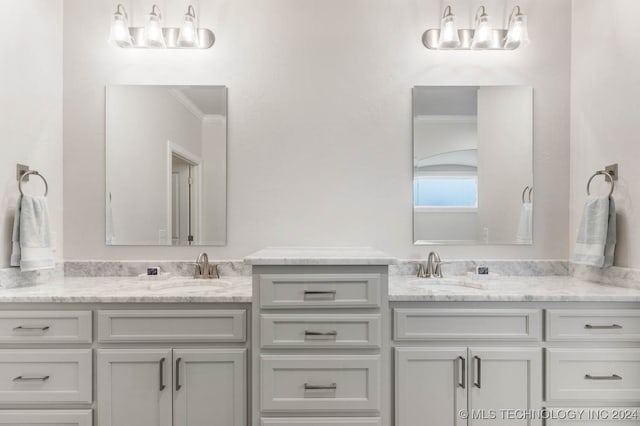 bathroom featuring crown molding and vanity