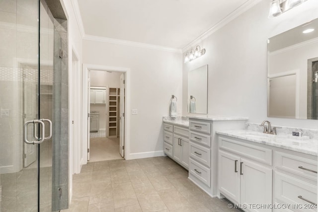 bathroom with tile patterned flooring, crown molding, vanity, and a shower with shower door