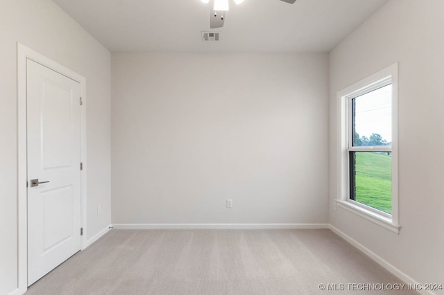 unfurnished room with ceiling fan and light colored carpet