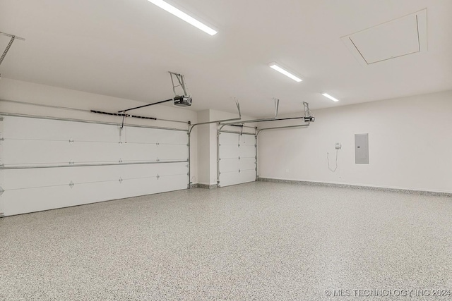 1734 W 115th Pl, Jenks, OK 74132 - garage with a garage door opener, electric panel, and baseboards