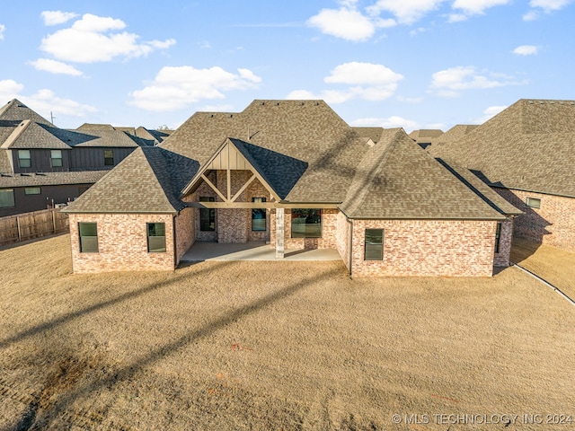 view of front of home featuring a patio and a front lawn