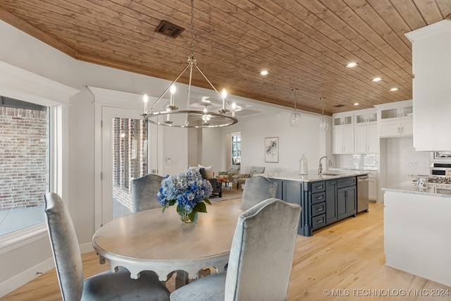 dining area with light wood-type flooring, plenty of natural light, an inviting chandelier, and wood ceiling