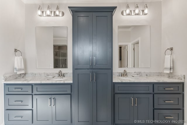 bathroom featuring crown molding and vanity