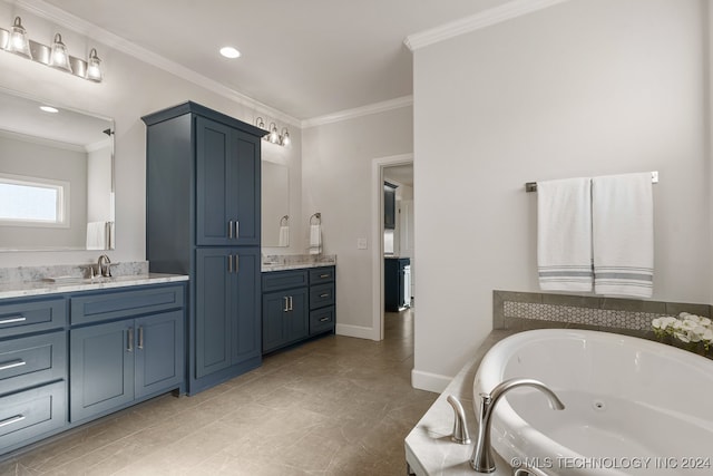 bathroom with tile patterned flooring, a tub, ornamental molding, and vanity