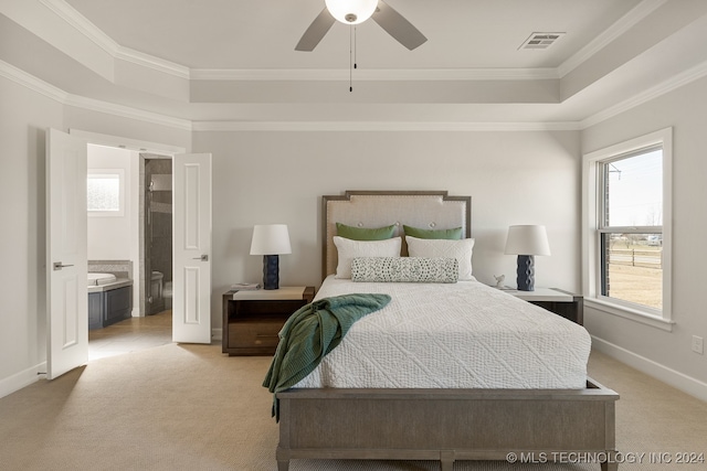 bedroom featuring crown molding, a raised ceiling, and light carpet