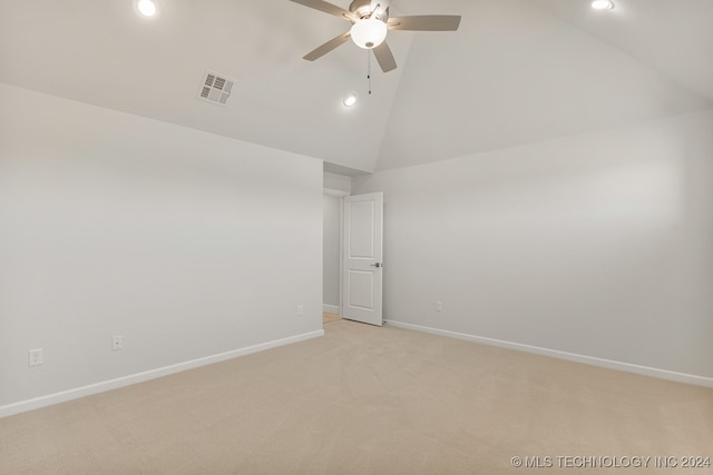 spare room featuring ceiling fan, high vaulted ceiling, and light carpet