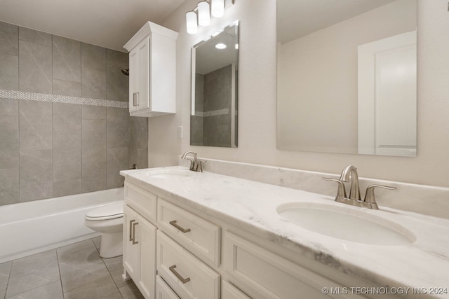 full bathroom with vanity, tiled shower / bath combo, toilet, and tile patterned floors