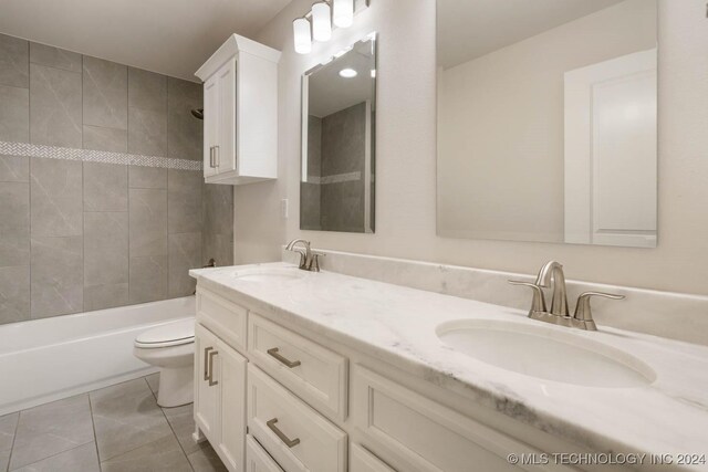 bathroom with toilet, double vanity, shower / bath combination, and tile patterned flooring