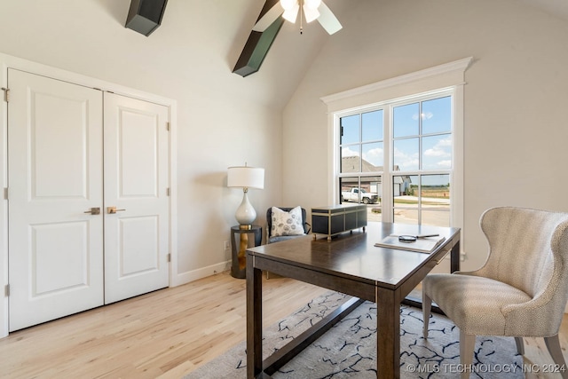 home office with vaulted ceiling, light hardwood / wood-style flooring, and ceiling fan