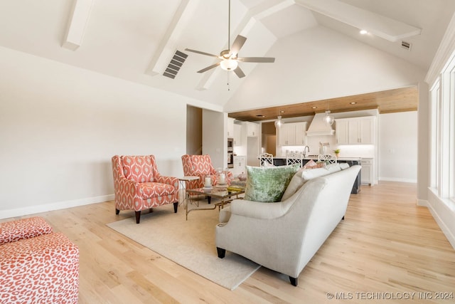 living room featuring light wood-type flooring, high vaulted ceiling, and ceiling fan