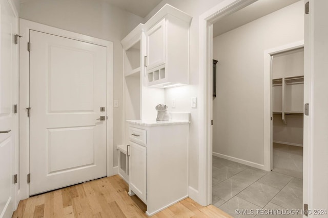 mudroom featuring baseboards and light wood-style floors