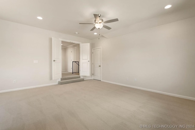 empty room with a ceiling fan, light carpet, recessed lighting, and baseboards