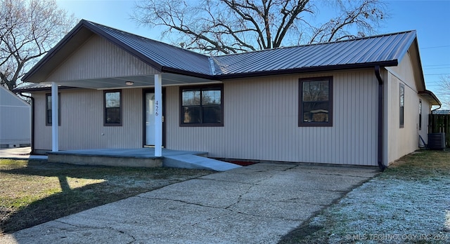 view of front of house with a porch and cooling unit