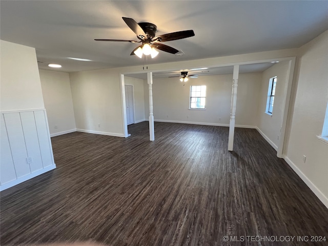 unfurnished bedroom with ceiling fan and dark wood-type flooring