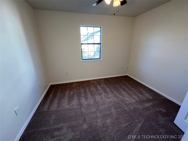 spare room featuring ceiling fan and carpet