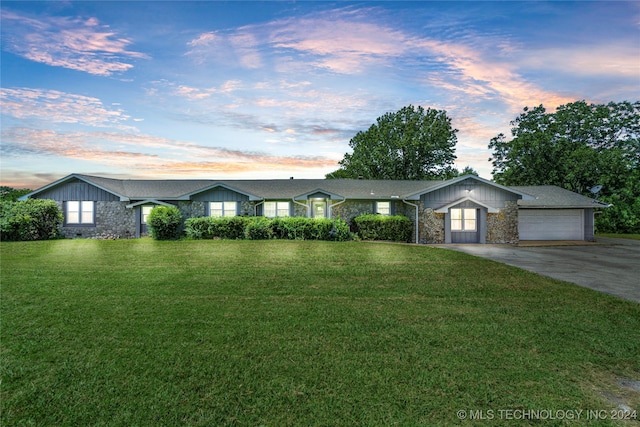 single story home with a yard and a garage