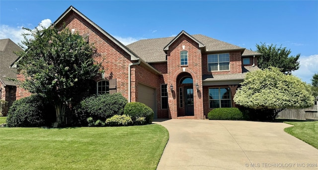 view of property with a front yard and a garage