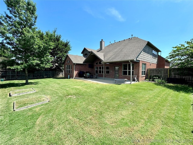 back of property featuring a patio area and a yard