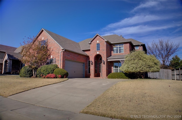 view of property with a front yard and a garage