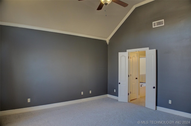 carpeted spare room featuring crown molding, high vaulted ceiling, and ceiling fan