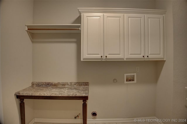 clothes washing area with cabinets, washer hookup, and gas dryer hookup