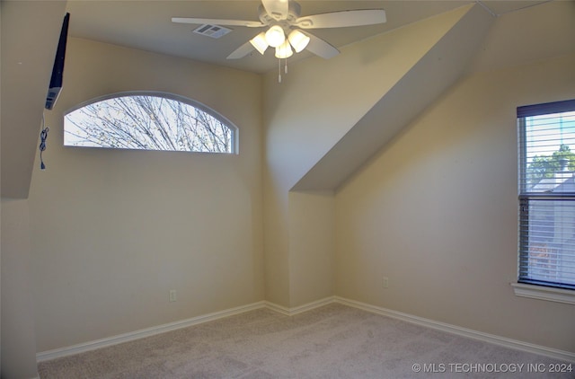 bonus room featuring light carpet and ceiling fan