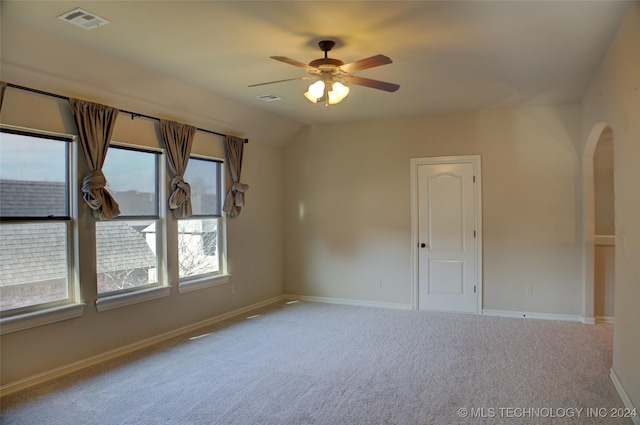 spare room featuring carpet flooring, ceiling fan, and lofted ceiling