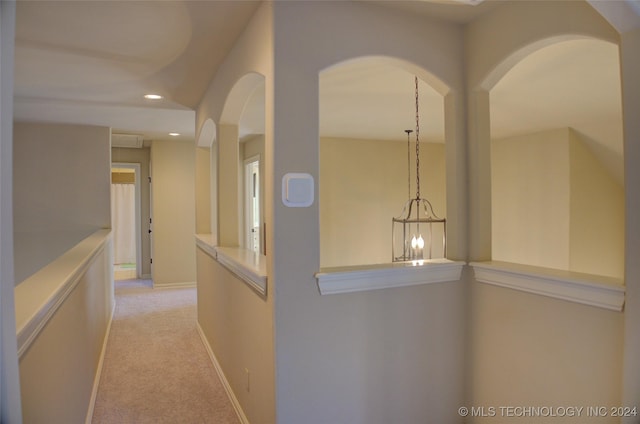 hall with light colored carpet