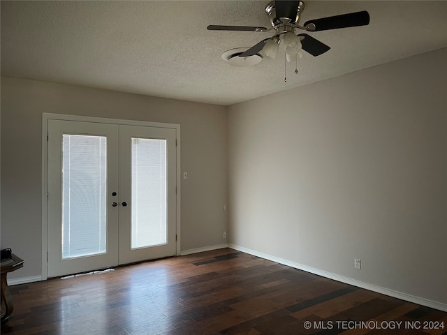 empty room featuring a textured ceiling, dark hardwood / wood-style floors, ceiling fan, and french doors