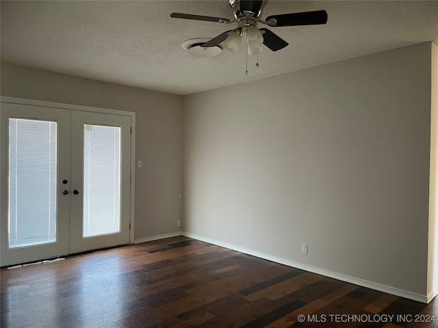 spare room with dark wood-type flooring, ceiling fan, french doors, and a textured ceiling