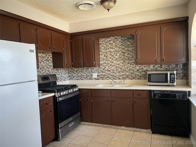 kitchen with decorative backsplash, appliances with stainless steel finishes, light tile patterned flooring, and sink