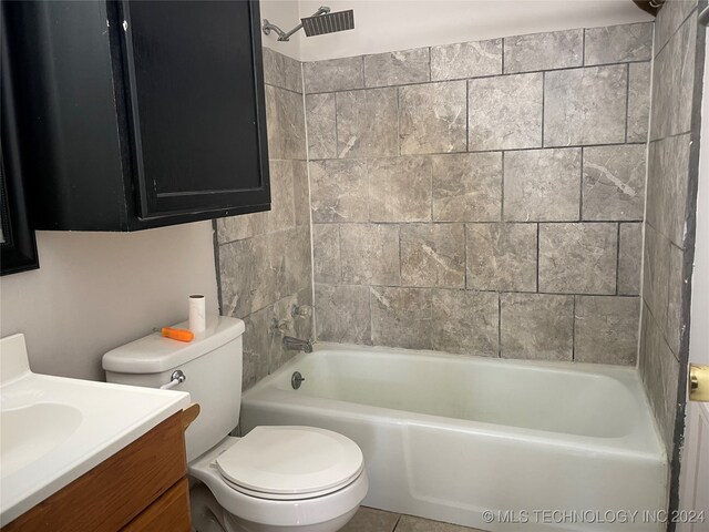 full bathroom featuring tile patterned floors, tiled shower / bath combo, vanity, and toilet