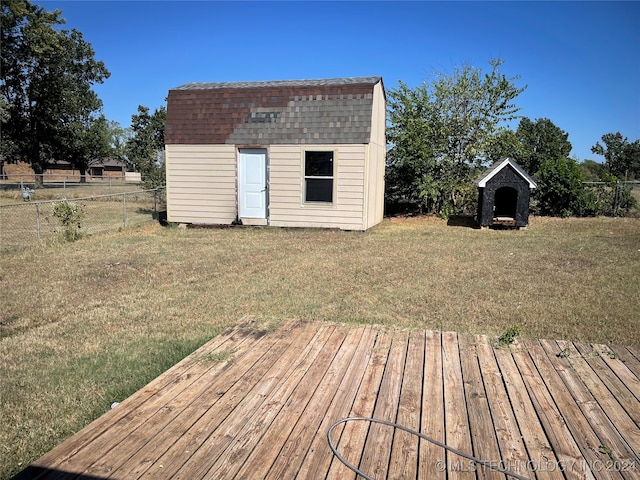 deck with a shed and a lawn