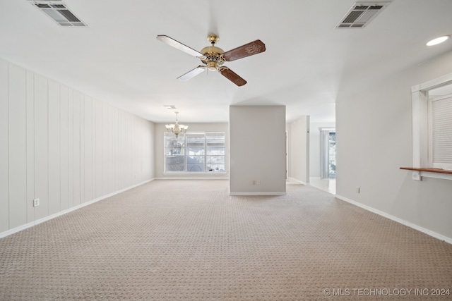 interior space featuring light colored carpet and ceiling fan with notable chandelier