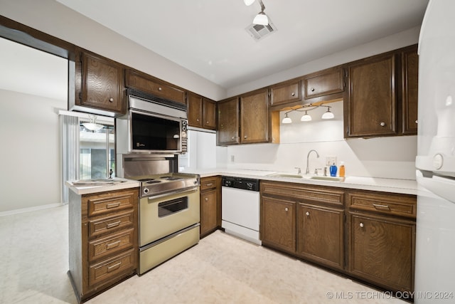 kitchen with dark brown cabinetry, sink, and appliances with stainless steel finishes