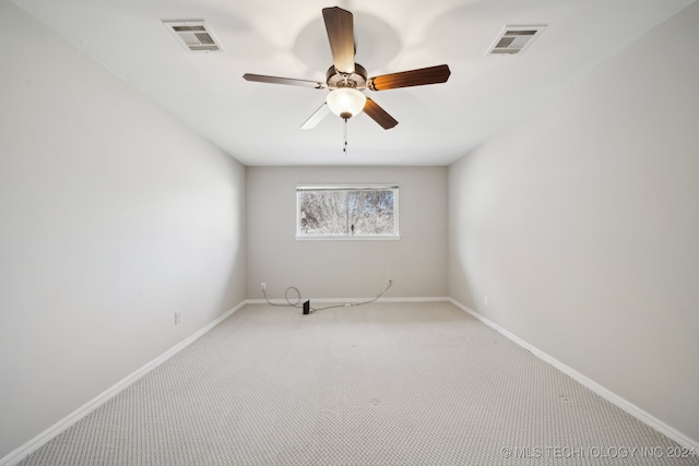 spare room featuring ceiling fan and carpet floors