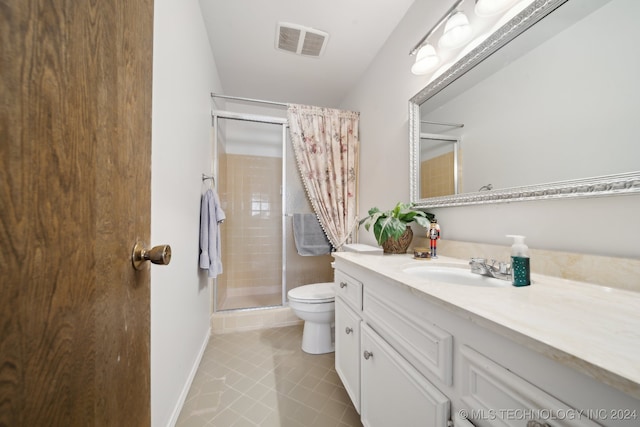 bathroom with a shower with shower curtain, vanity, tile patterned floors, and toilet