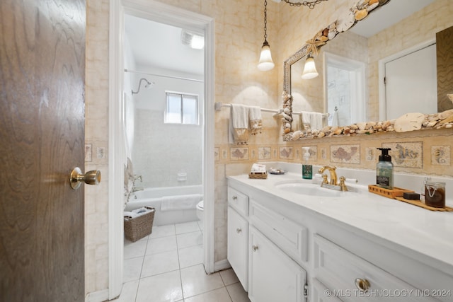 full bathroom with tile patterned floors, vanity, tiled shower / bath combo, and toilet