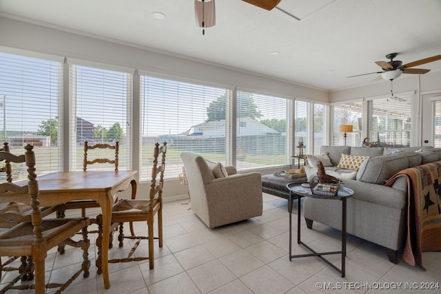 tiled living room featuring ceiling fan and crown molding