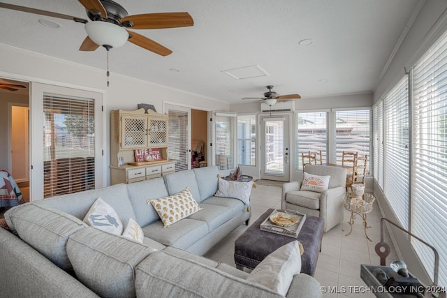 tiled living room featuring ceiling fan and ornamental molding