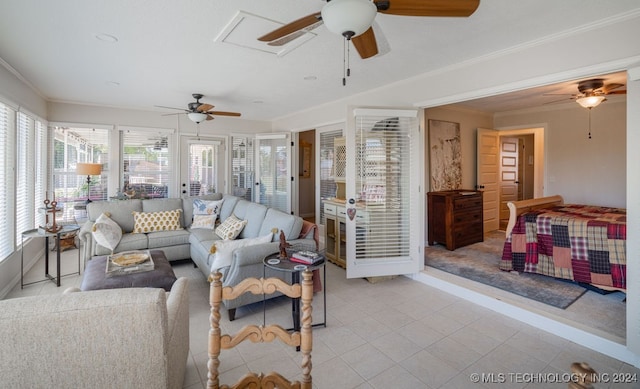 tiled living room with ceiling fan and ornamental molding