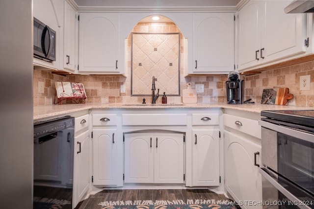 kitchen with dark hardwood / wood-style flooring, white cabinets, black appliances, and sink