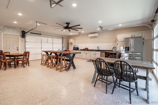 dining area featuring sink, ceiling fan, and a wall mounted AC