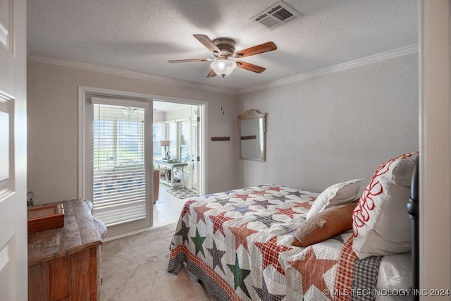 bedroom featuring ceiling fan, a textured ceiling, light colored carpet, and ornamental molding