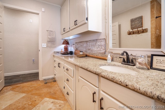 bathroom featuring ornamental molding, vanity, and tile patterned floors