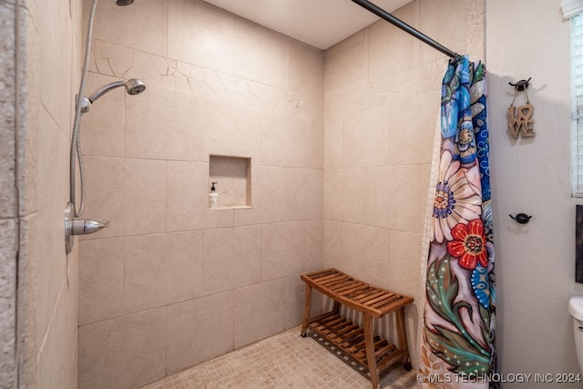 bathroom featuring toilet and a shower with curtain