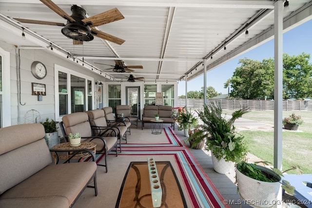 sunroom featuring ceiling fan