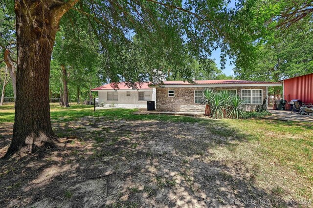 back of house with a lawn