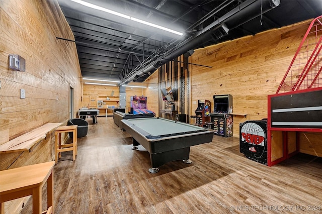 game room featuring pool table, wood walls, and wood finished floors