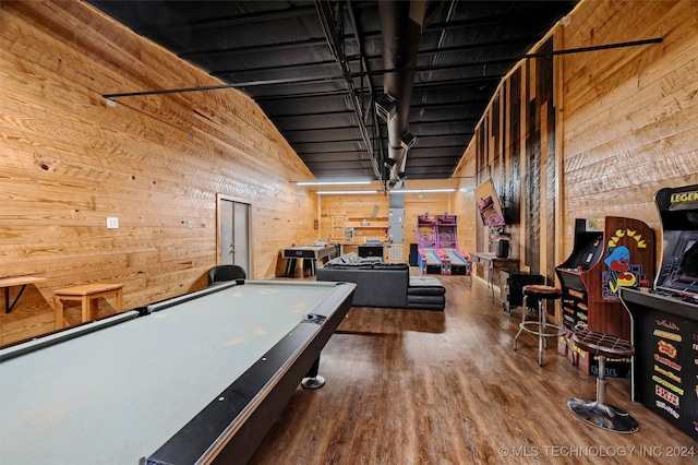 rec room with pool table, high vaulted ceiling, wood finished floors, and wooden walls